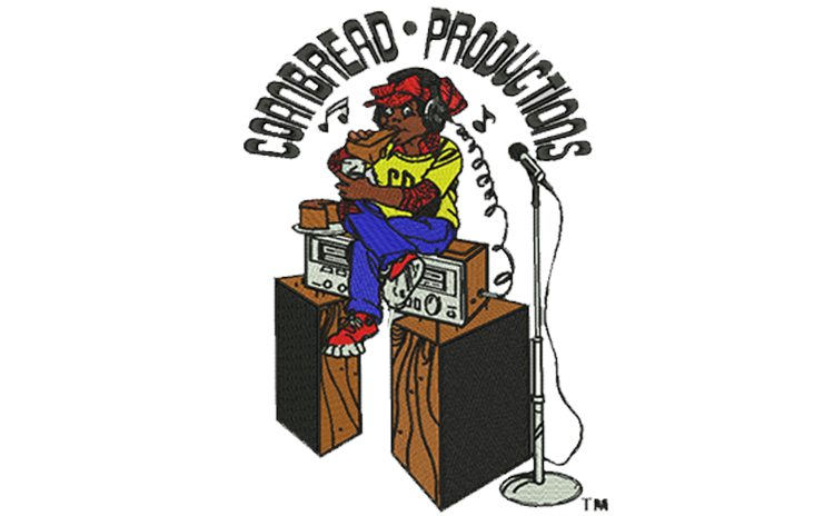 Embroidery digitizing sample: a cartoon character seated on stacked speaker cabinets at a studio microphone.