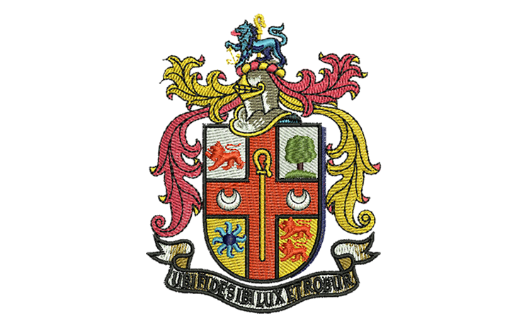 Embroidery digitizing sample: a full-color heraldic coat of arms with a crest, mantling and a motto scroll.
